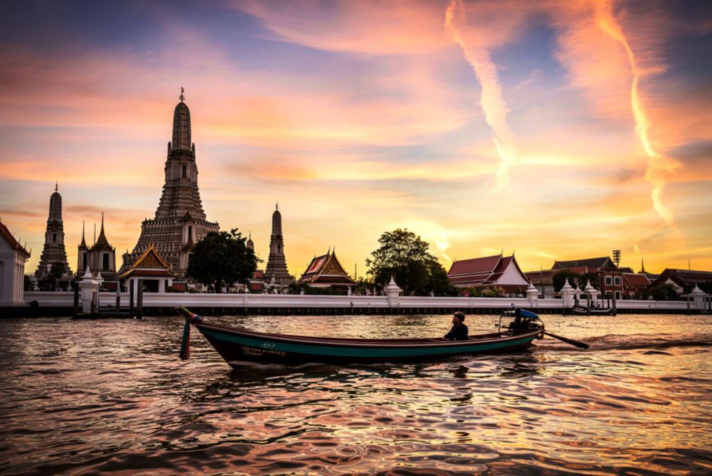 off-path-thailand-bangkok-chao-phraya-river-boat Longtail boat on the Chao Phraya River at sunset with Bangkok’s skyline in the background