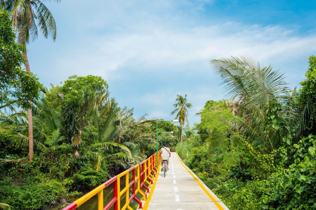 cyclist riding through lush greenery and narrow trails in Bang Krachao Bangkok’s Green Lung
