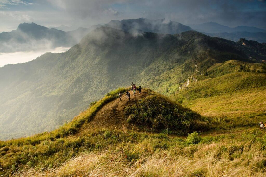 Mountain peaks and green valleys of Chiang Dao Thailand with distant hill tribe figures on a ridge