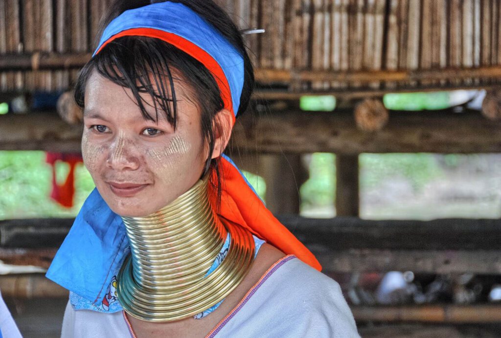 off-path-thailand-karen-hill-tribe Karen long-neck hill tribe woman wearing traditional brass rings.