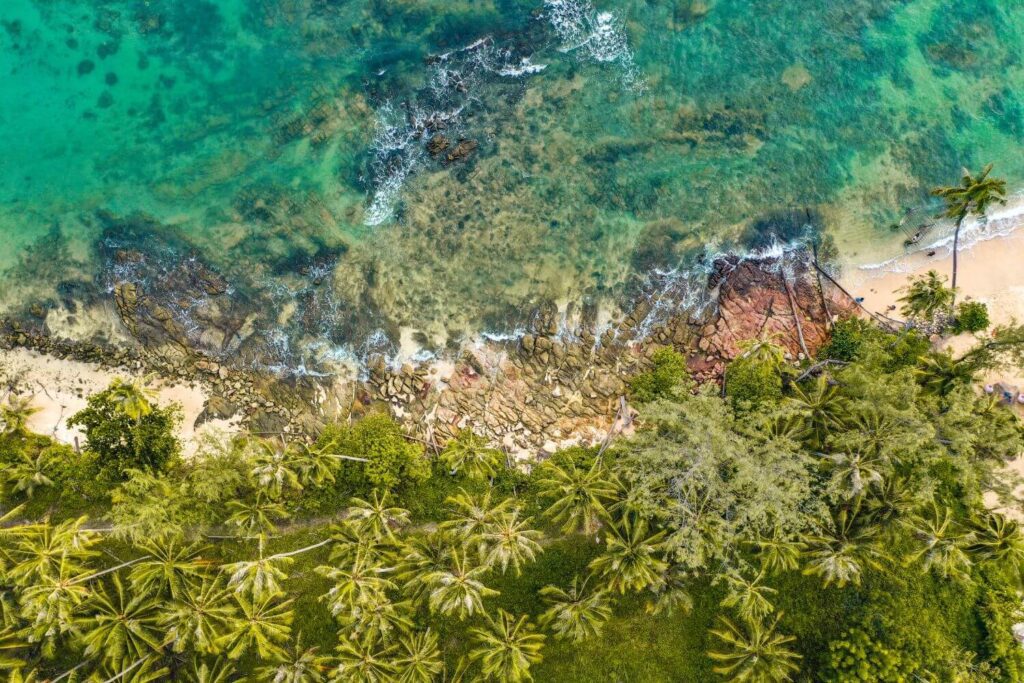 Bird’s-eye view of Koh Kood beach Thailand with coral reefs and clear shallow waters