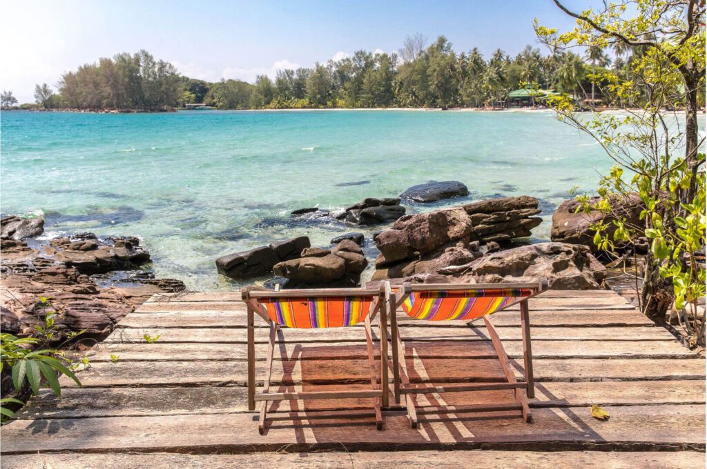 off-path-thailand-koh-kood-beach-chairs Two beach chairs facing the turquoise sea on Koh Kood, one of Thailand’s most peaceful hidden islands.