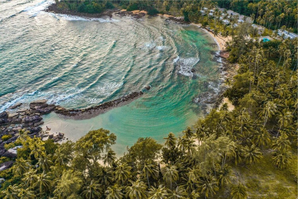 Aerial view of Koh Kood Thailand showing turquoise sea and palm-lined beach