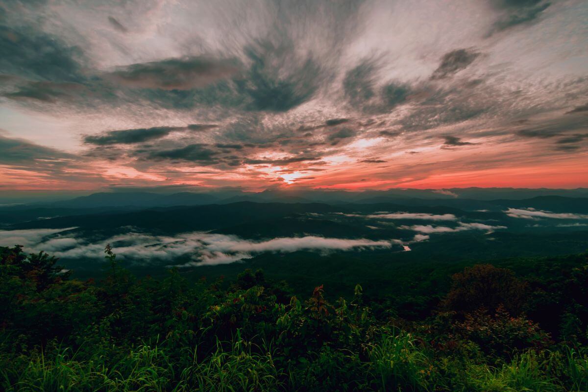 Nan Thailand itinerary: golden sunset over mountain ridges and Nan River valley