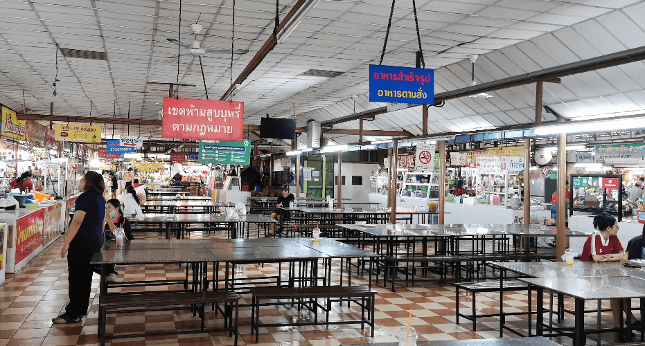 Local market scene at Ladprao 101 in Bangkok with vegan stalls and everyday Thai food options