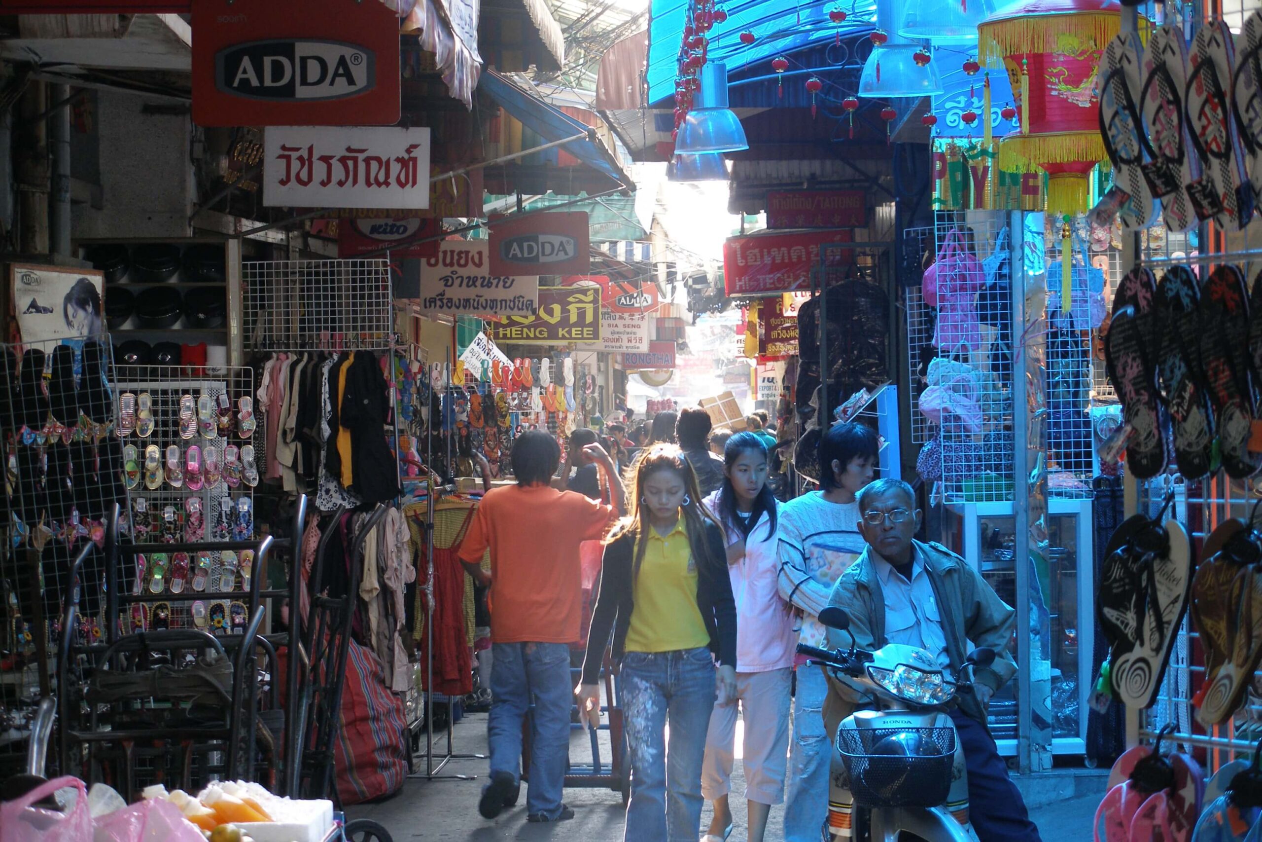 Sampheng Market wholesale lane in Bangkok with bags and goods