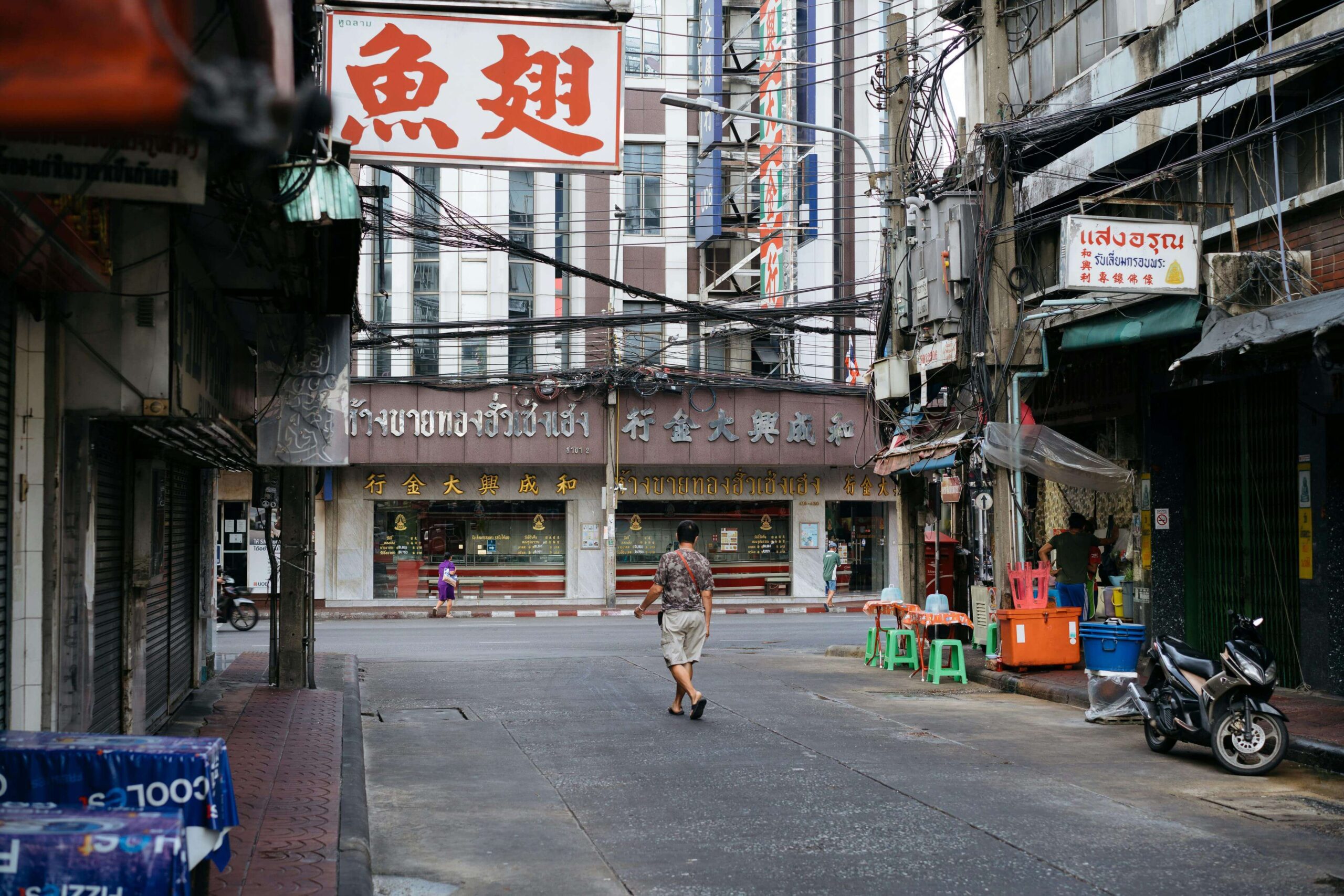 Chinatown street scene in Bangkok with layered signage and market energy
