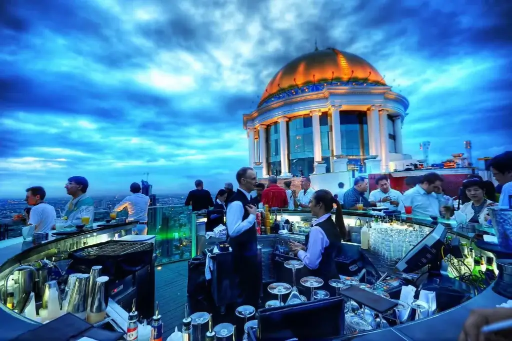 Lebua Sky Bar rooftop terrace overlooking Bangkok skyline and the Chao Phraya River at sunset in 2026