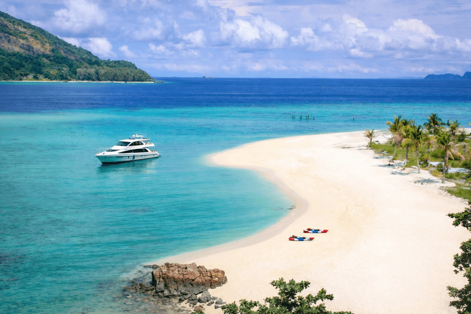 Private yacht anchored near a secluded beach in South Thailand