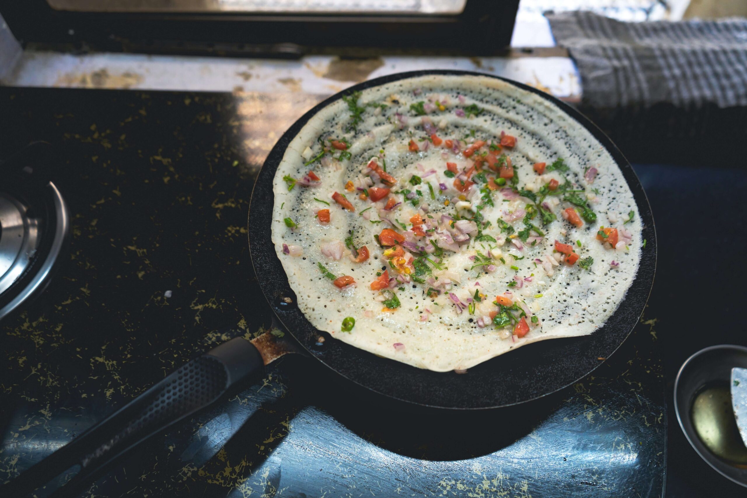 off-path-thailand-bangkok-ganesha-restaurant Chef spreading dosa batter on a hot griddle in Bangkok, a vegan-friendly option